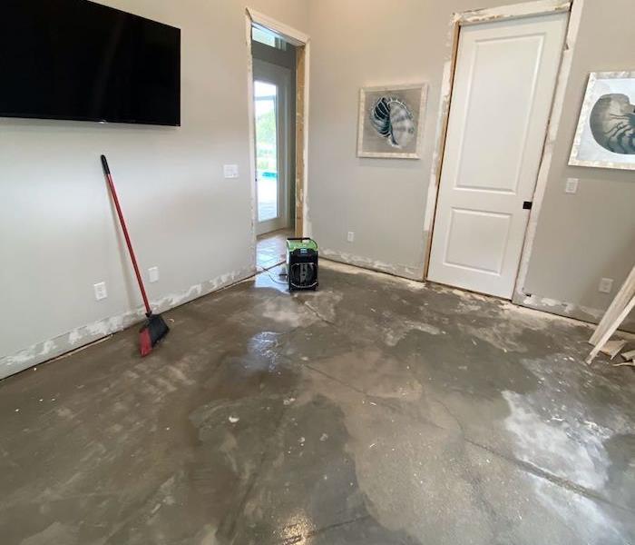 Room with wet floor and water cleanup tools