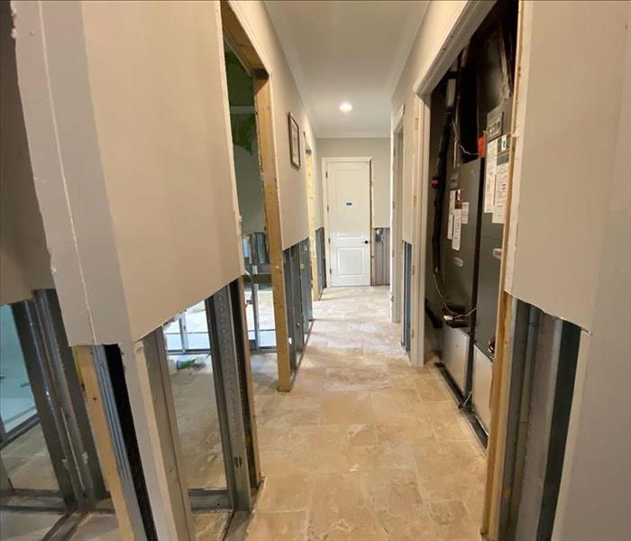 Hallway with bare floor and walls with flood cuts