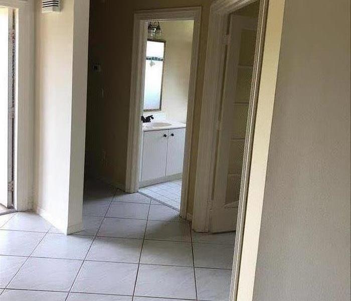 home hallway with tile floor and three doorways