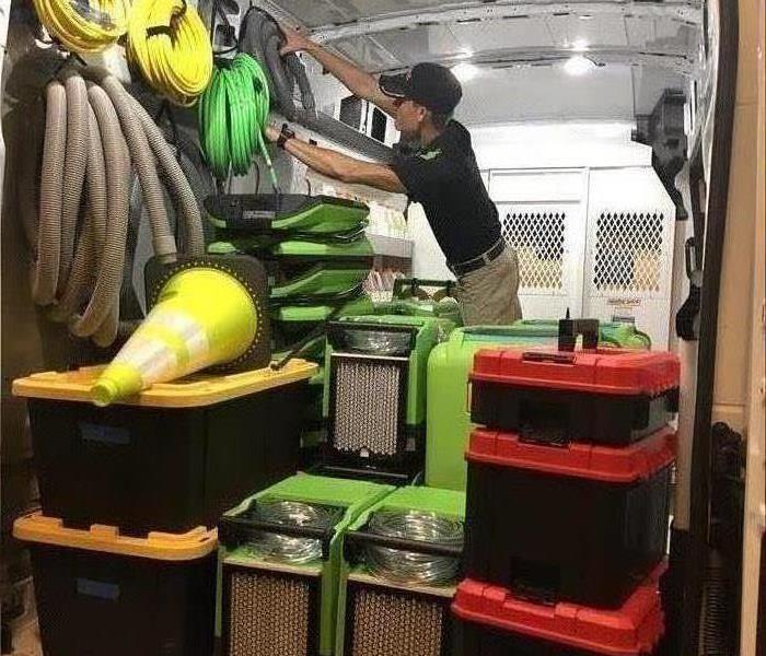 Man Organizing A Work Van For Storm Preparation